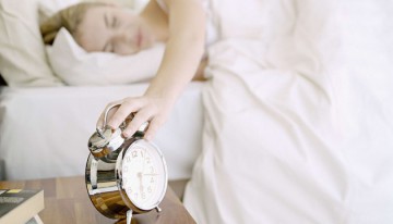 Mandatory Credit: Photo by OJO Images / Rex Features ( 826510a ) MODEL RELEASED Alarm clock and woman in bed sleeping VARIOUS /REX_OJOFEM235_826510a//0903161927